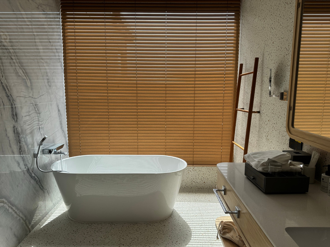 Basswood venetian blinds in a spa-inspired room with natural light and contemporary interior