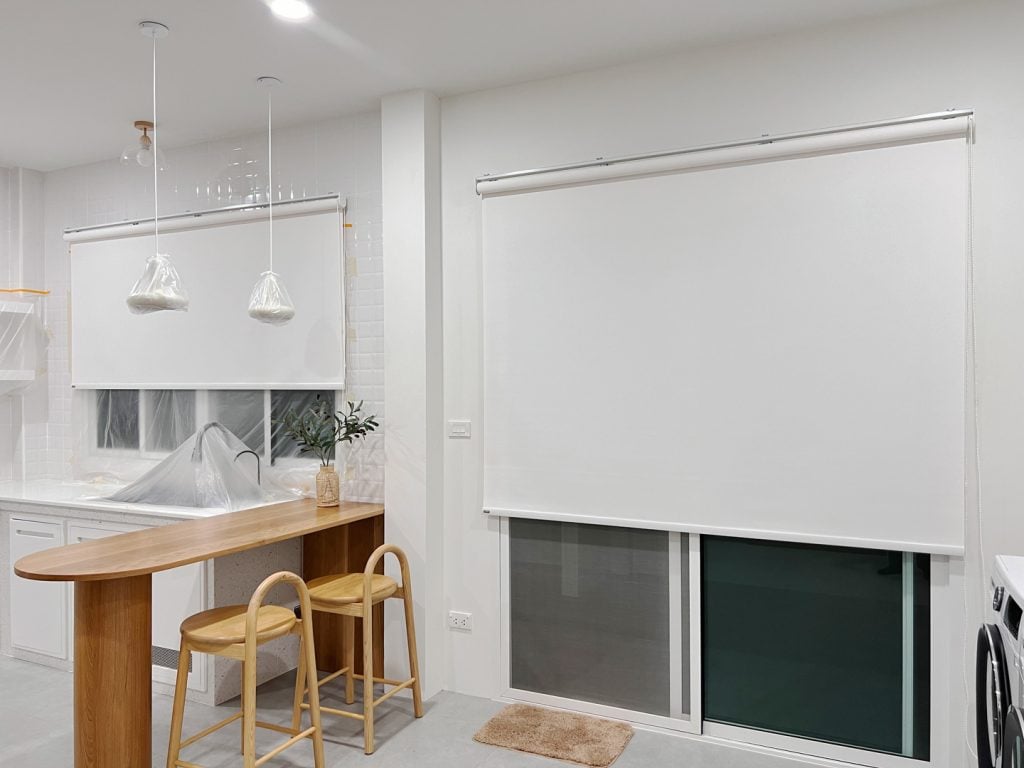The window and the door protect the light from outside by roller blinds