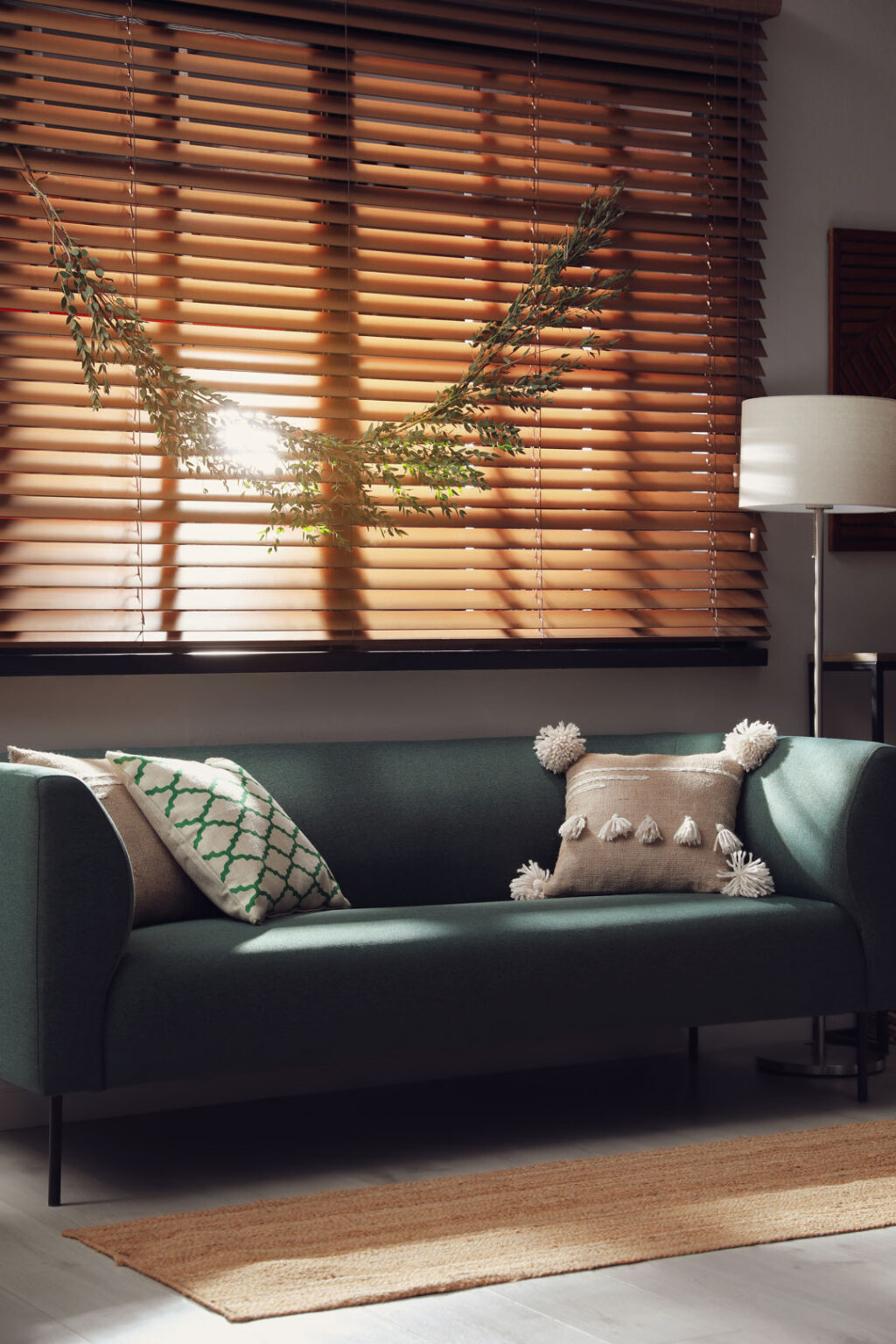 Stylish room decorated with beautiful eucalyptus garland and blinds