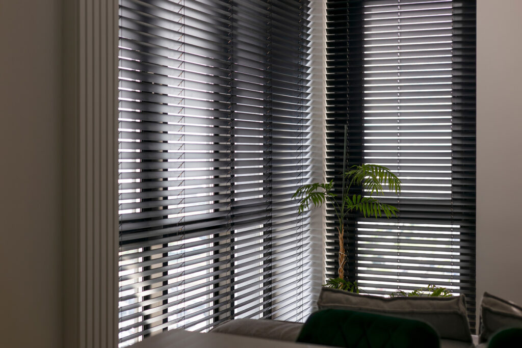 Sunlight gently filters through wood venetian blinds