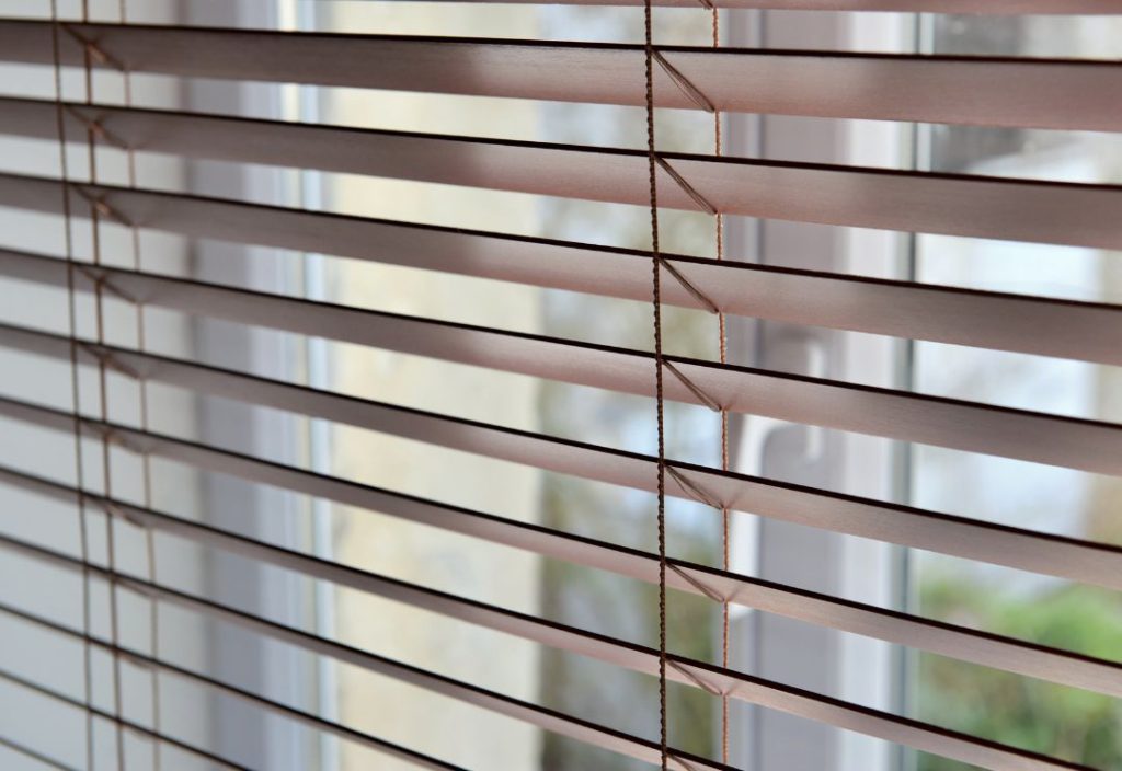 A close-up, angled view of brown wooden horizontal blinds.