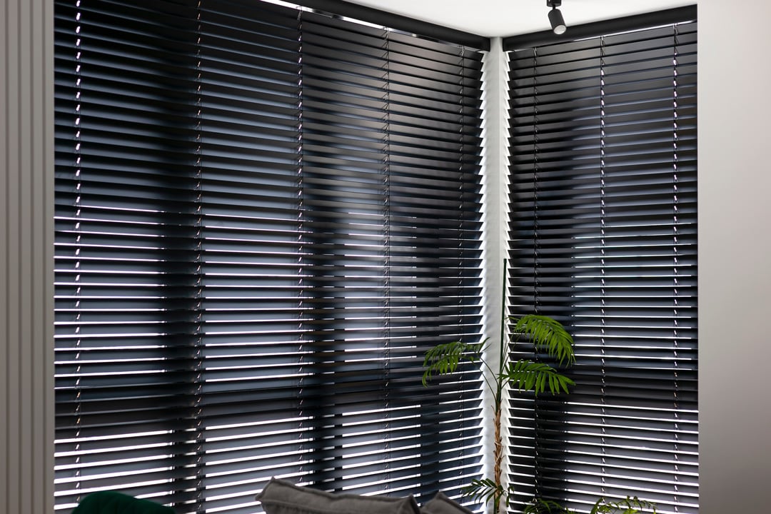 Black motorised timber venetian blinds in a modern interior