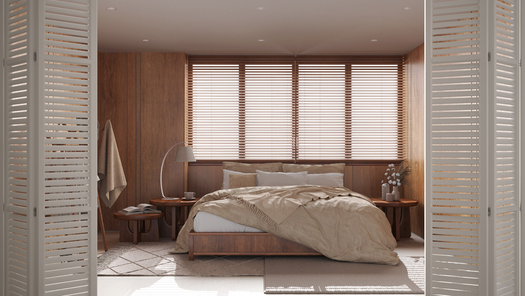 An elegant bedroom with wood-paneled walls, a large bed with tan linens, and a wide window covered by wooden horizontal blinds