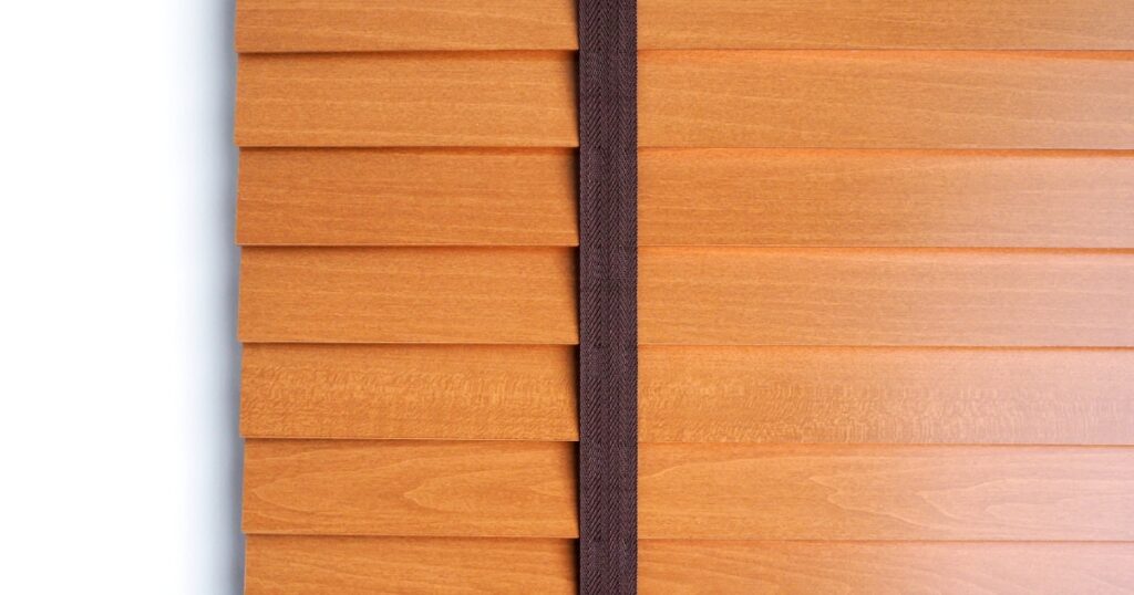 A close-up of horizontal wood-grain blinds