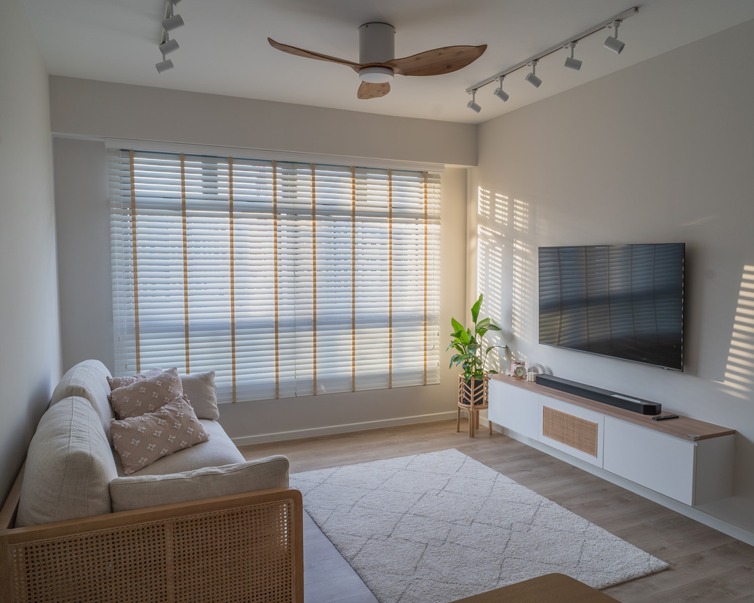 a large window with white blinds and tan decorative tapes