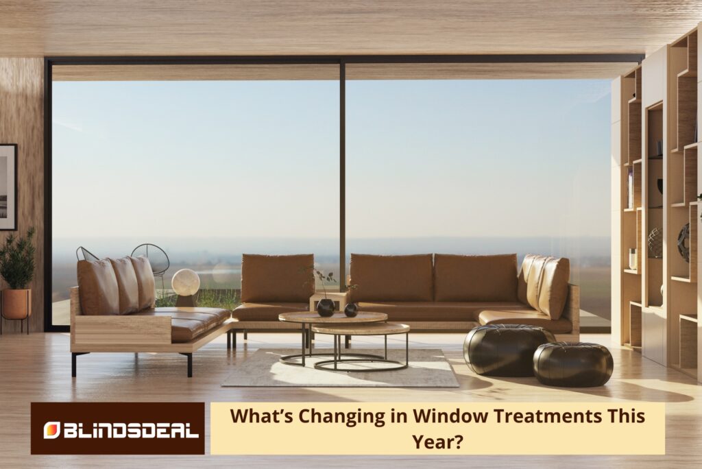 A wide, sun-drenched shot of a minimalist living room with floor-to-ceiling windows overlooking a horizon
