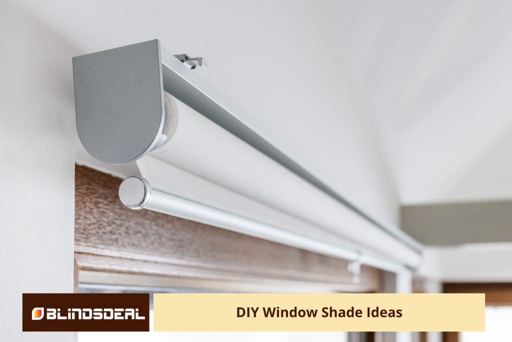 A low-angle, close-up shot showing the top mechanism and grey cassette of a roller blind installed on a white wall