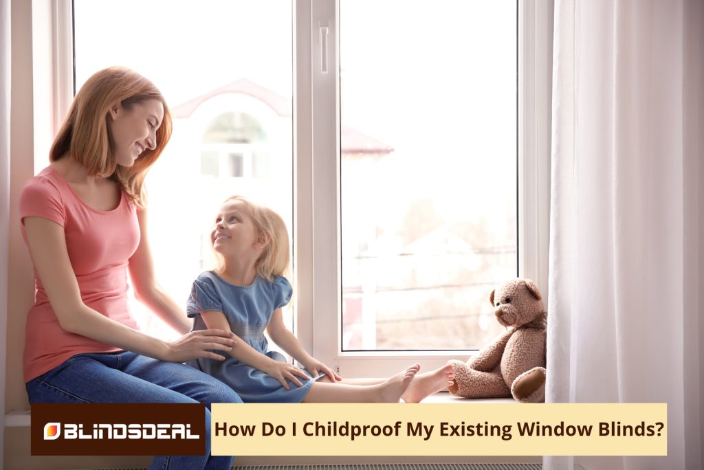 A mother and young daughter sitting on a windowsill next to a teddy bear