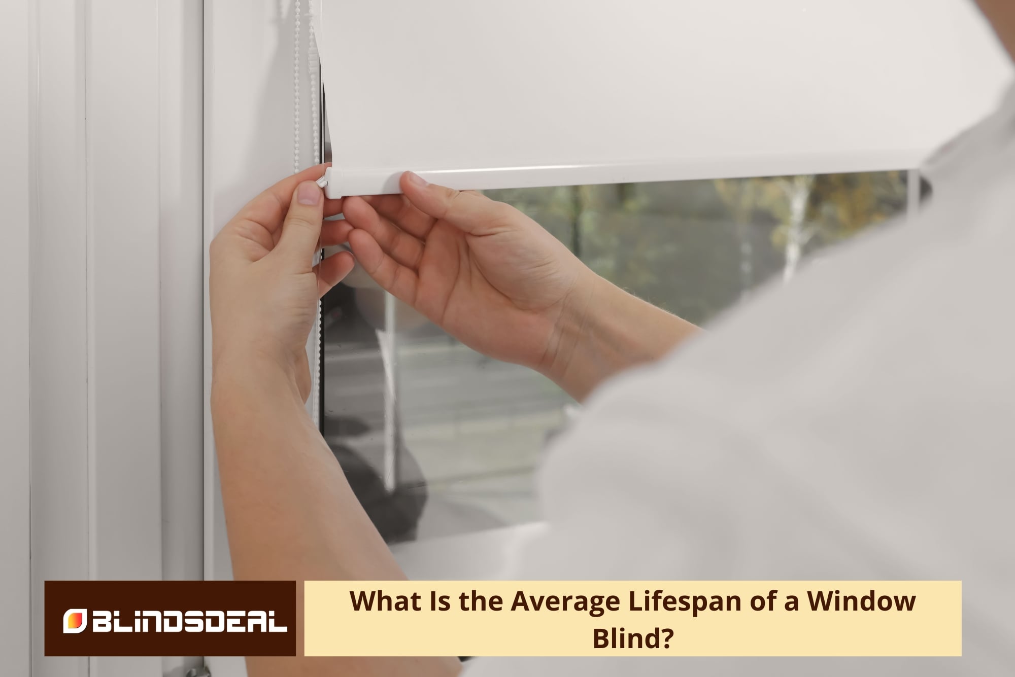 A person adjusting a white roller blind.