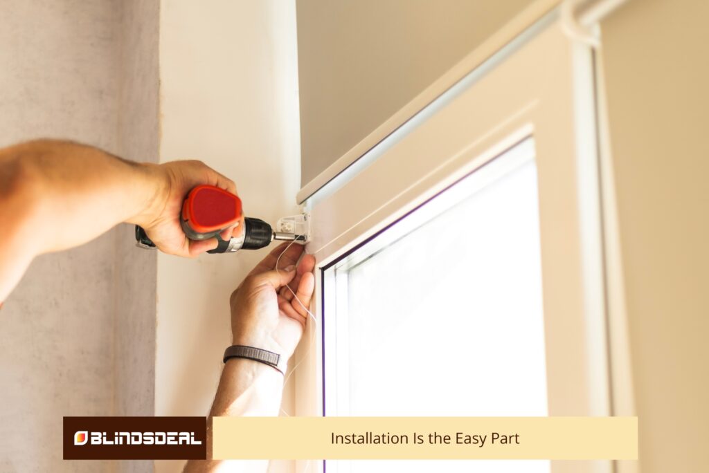 Installer drilling a bracket into place to mount window blinds.