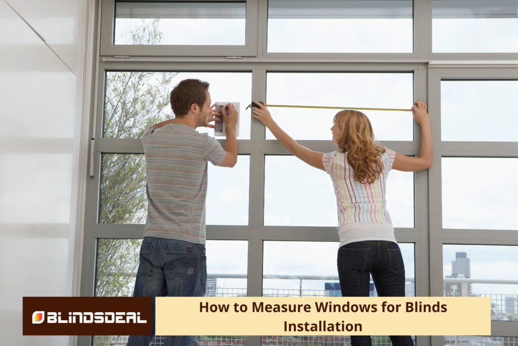 A man writing on notes while a woman uses a tape measure across a window frame