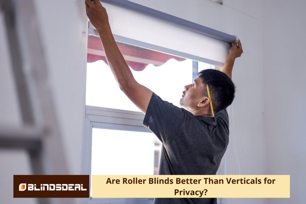 A man installing a grey roller blind over a window